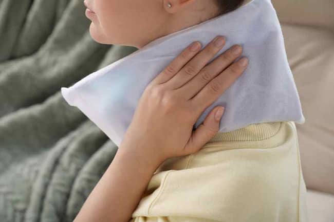 person using a heating pad as an home remedies for muscle relaxers